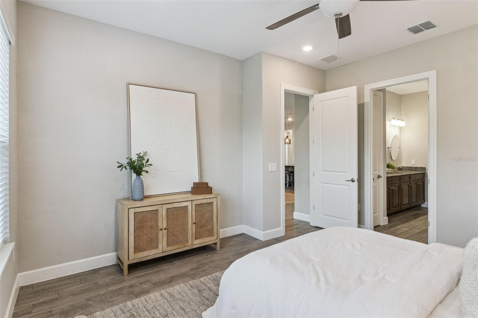 Second primary bedroom with neutral finishes and view toward the hallway. - 4108 VIA TOLEDO CT, POINCIANA