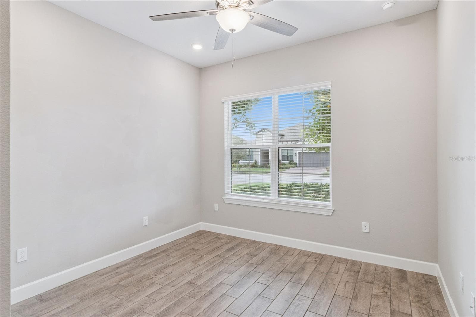 Third bedroom with ceiling fan, ideal for guests, a home office, or hobbies. - 4108 VIA TOLEDO CT, POINCIANA