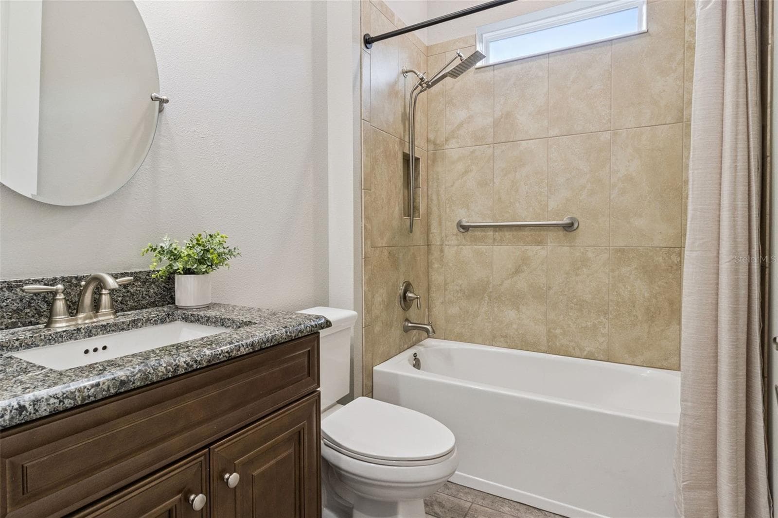 Third full bathroom with tub and shower combination and granite vanity. - 4108 VIA TOLEDO CT, POINCIANA