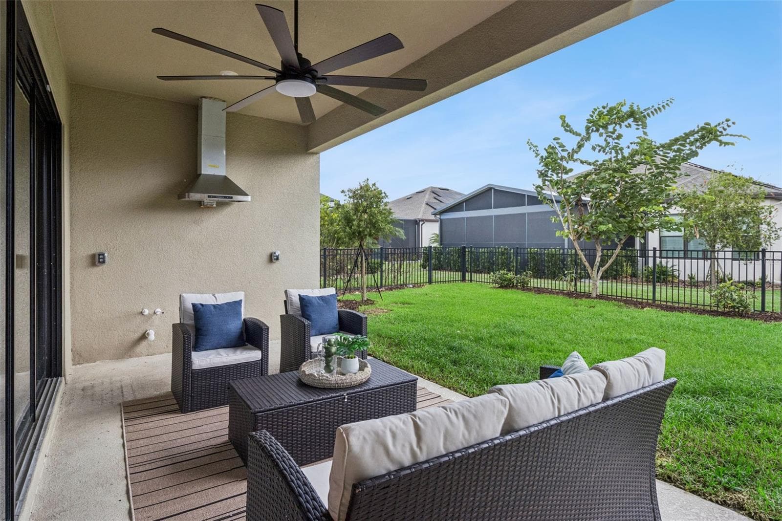 Private fenced patio with ceiling fans, perfect for relaxing or entertaining. - 4108 VIA TOLEDO CT, POINCIANA