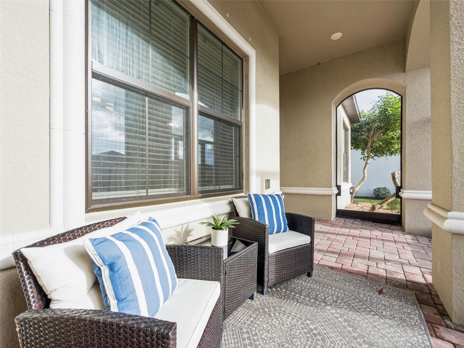 Screened front porch with seating, a welcoming place to relax and enjoy the Florida lifestyle. - 4108 VIA TOLEDO CT, POINCIANA