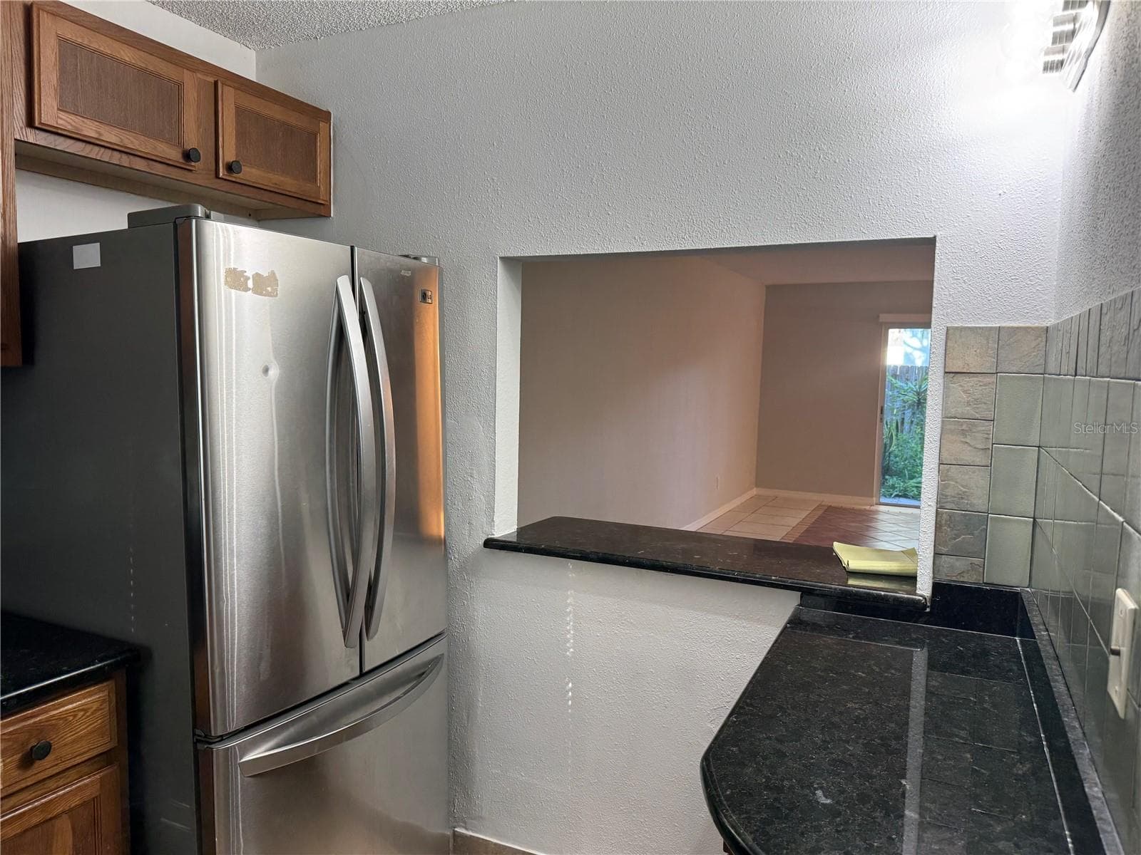 FROM SINK LOOKING TO REFRIGERATOR COFFEE & SMALL APPLIANCE STATION BREAKFAST BAR - 2884 SOMERSET PARK DR #2907, TAMPA