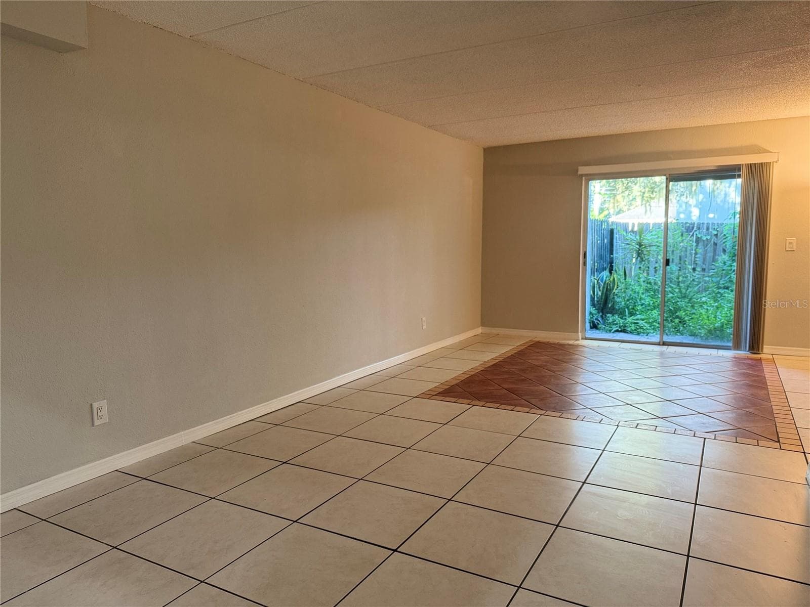 FROM FOYER TO 1ST FLOOR REAR PATION & LAUNDRY - 2884 SOMERSET PARK DR #2907, TAMPA