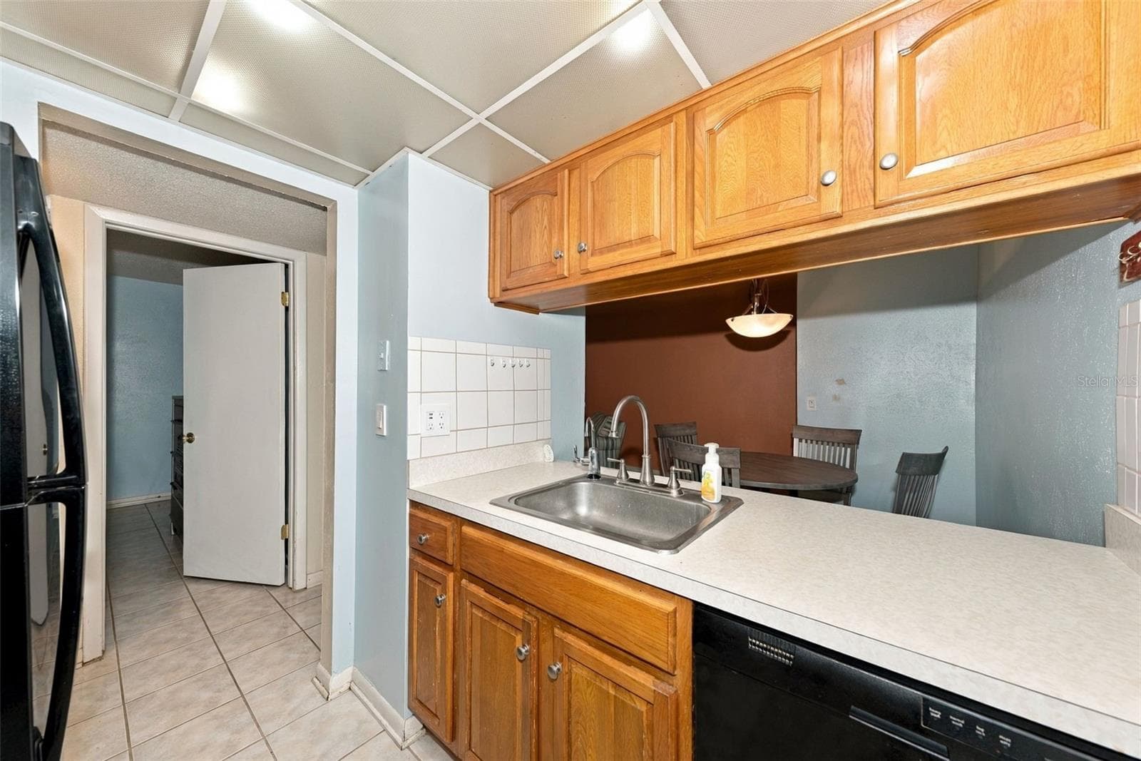 kitchen opens to dining room - 1799 N HIGHLAND AVE #159, CLEARWATER