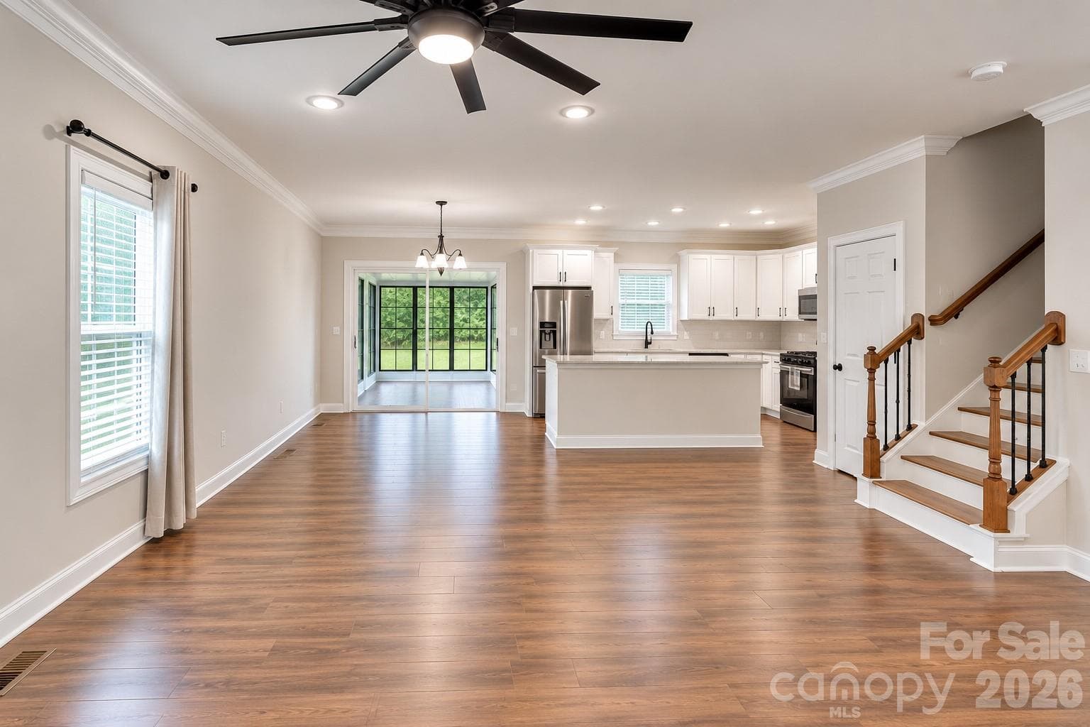 Large open living area opens up into foyer, kitchen, dining and leads to a hallway for pantry, dropzone, laundry, half bath and garage. - 317 Oak Brook Drive, Salisbury