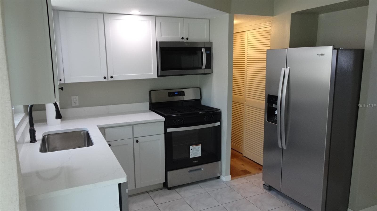 Natural gas stove. Pantry in the hallway. - 7809 38TH TER N, ST PETERSBURG