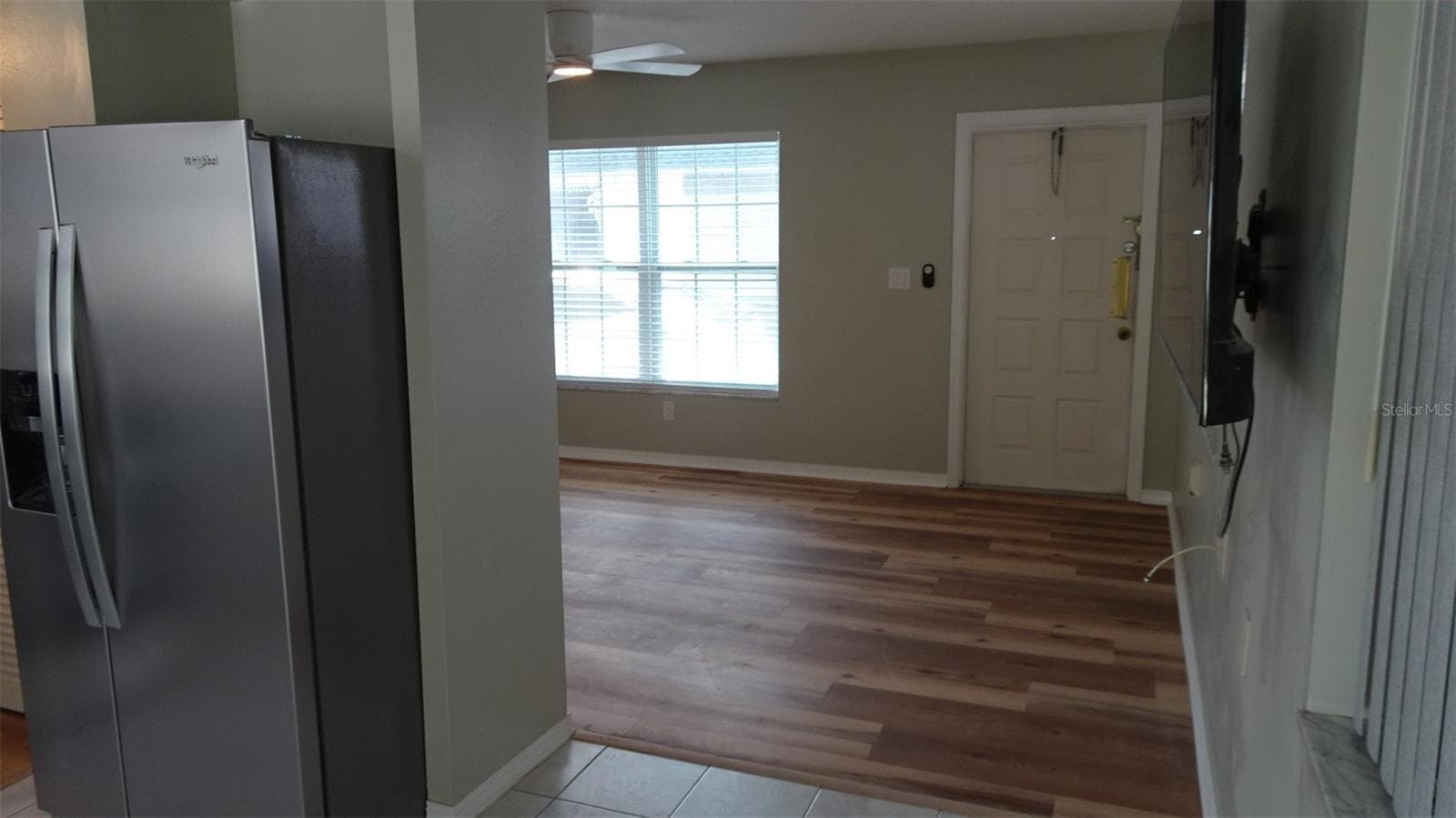 From dining area into living room.. Would you like the wall mounted TV to stay? Just ask. - 7809 38TH TER N, ST PETERSBURG