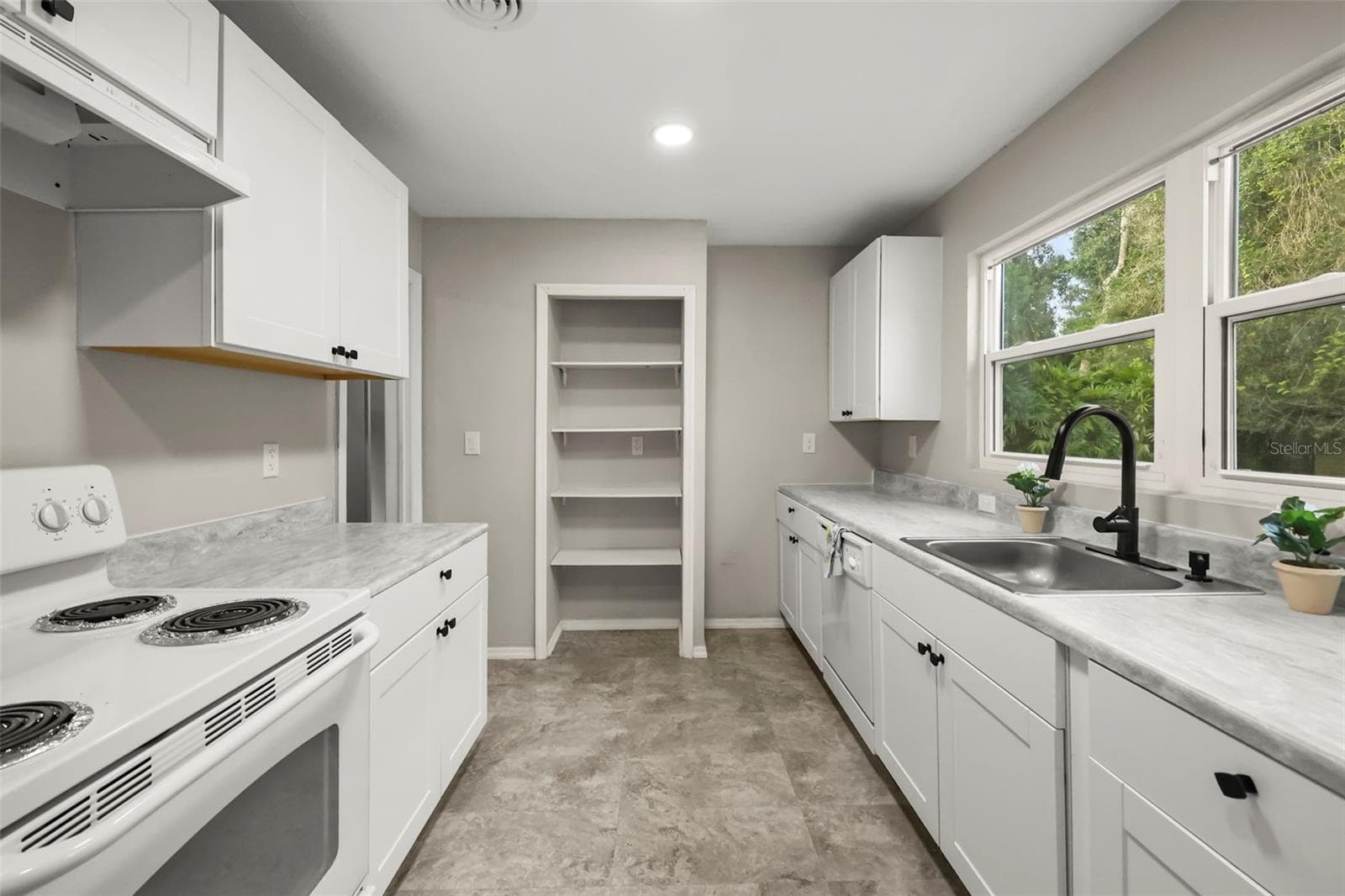 Galley kitchen with plenty of counter space and storage - 2410 ORANGE AVE, SANFORD