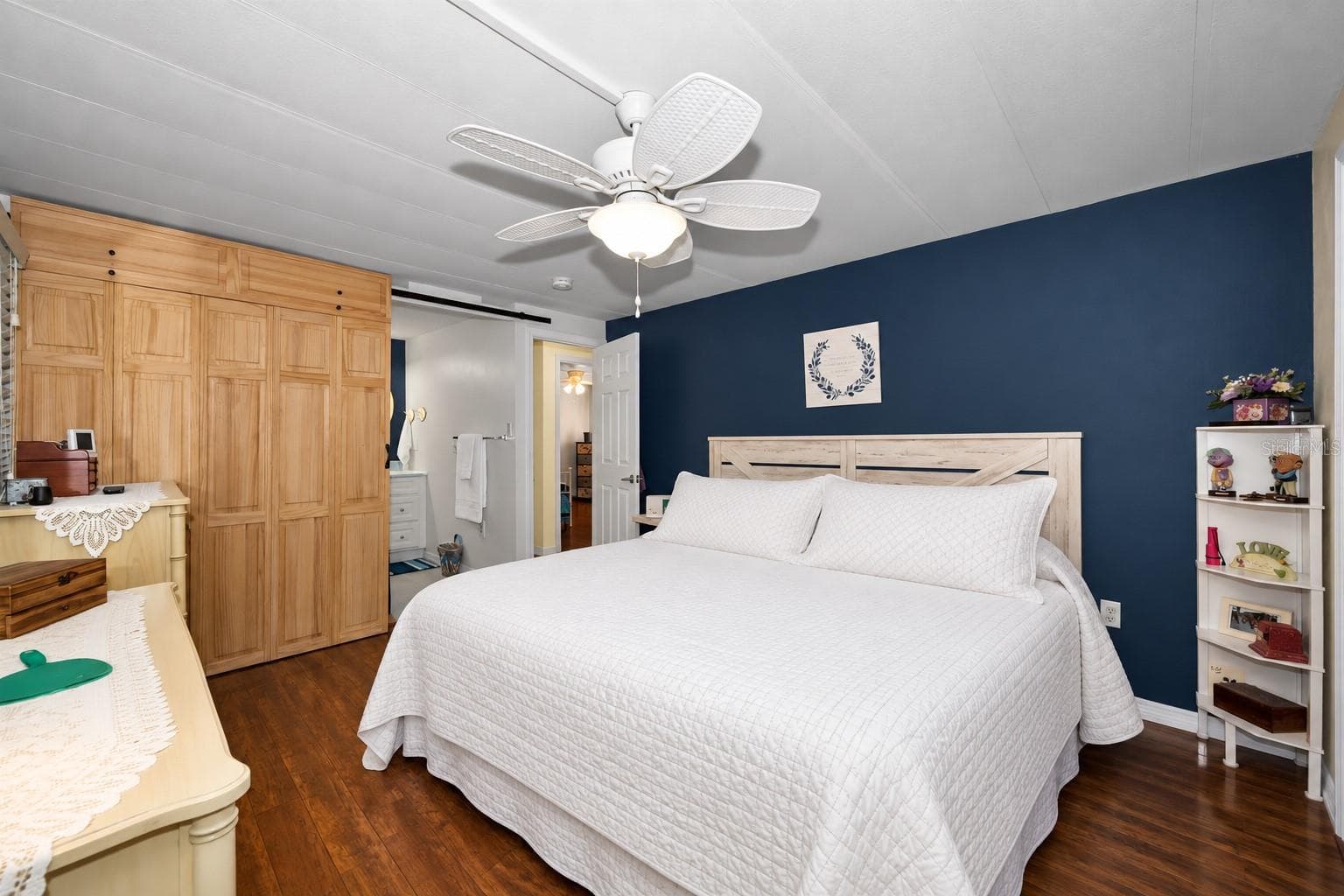 Barn door opens to the ensuite bath - 143 MELODY LN, TARPON SPRINGS