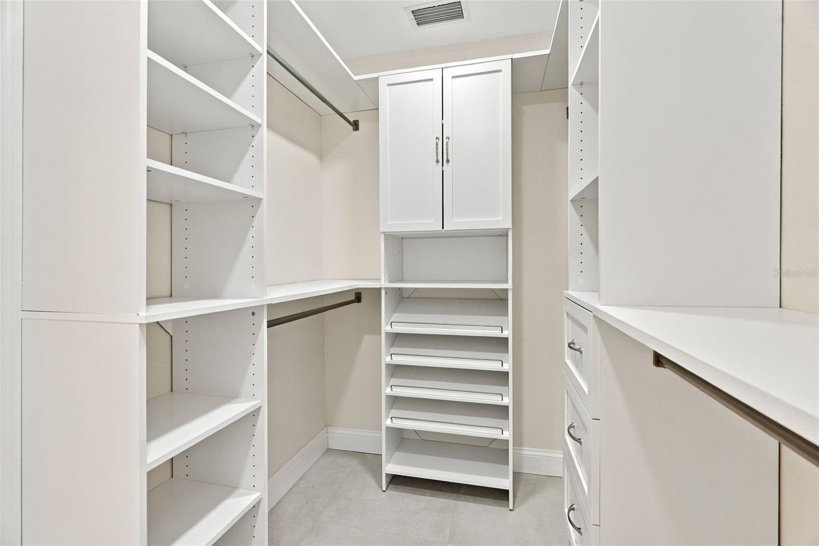 A walk-in closet with custom built-ins for the ultimate in organization. - 625 FOLSOM ST S, ST PETERSBURG