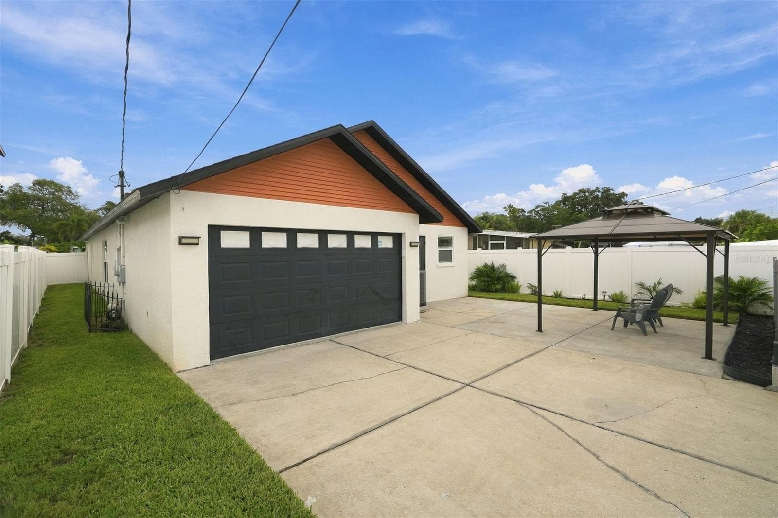 Desirable alley access through a remote-controlled electric gate leads to the two-car garage, adding both privacy and convenience. - 625 FOLSOM ST S, ST PETERSBURG