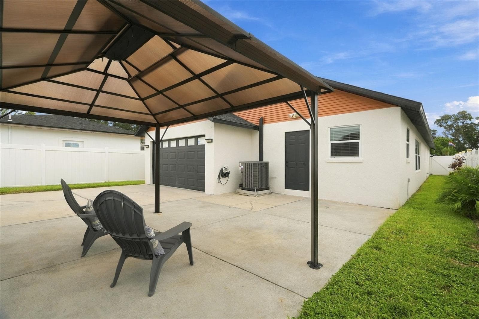 A fully fenced yard, pergola, and entertaining area create a perfect setting for grilling, dining, and relaxing. - 625 FOLSOM ST S, ST PETERSBURG