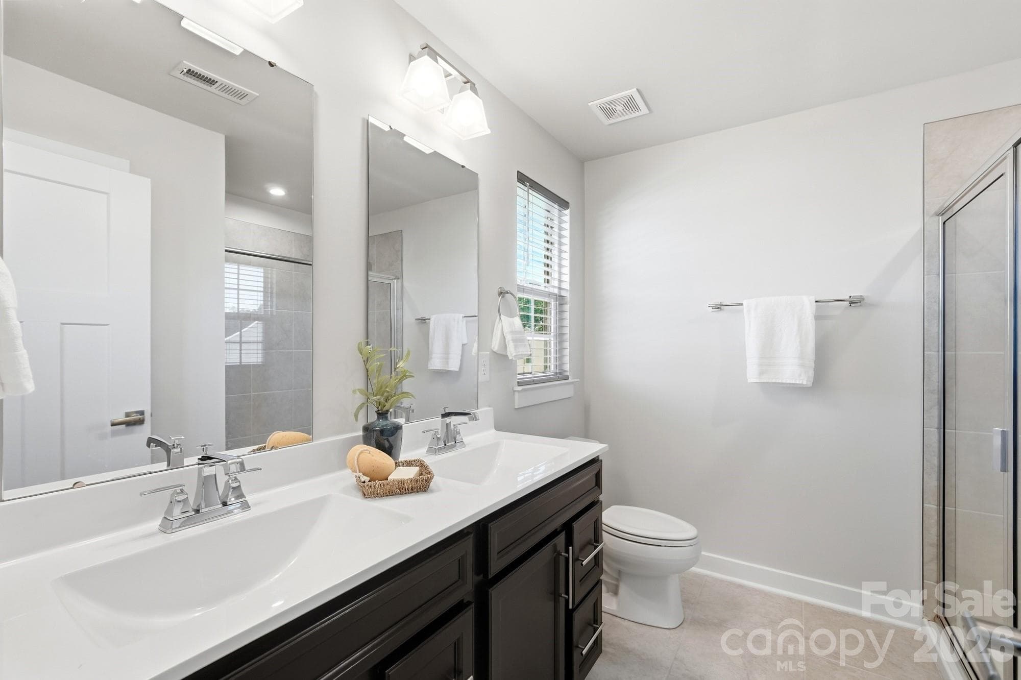 Primary bedroom with dual vanities - 1857 Giana Lane, Monroe