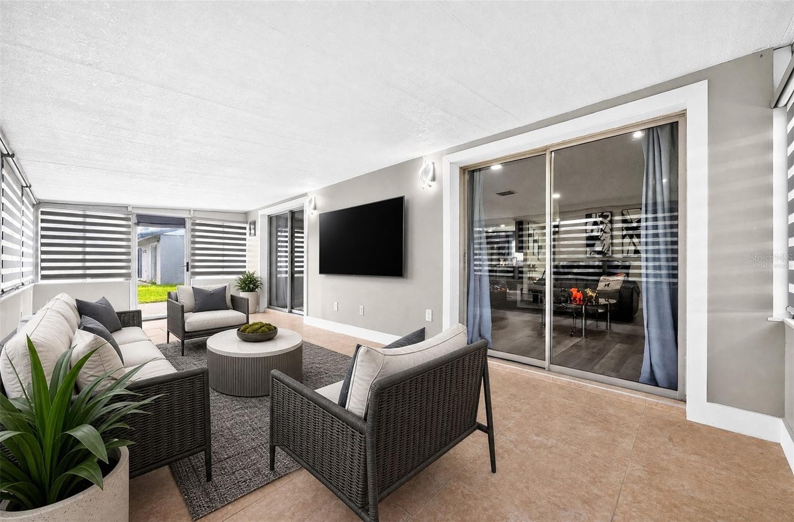 Two sets of sliding glass doors open up to the enclosed lanai. Virtually Staged. - 10113 ALLENBY CT, ORLANDO