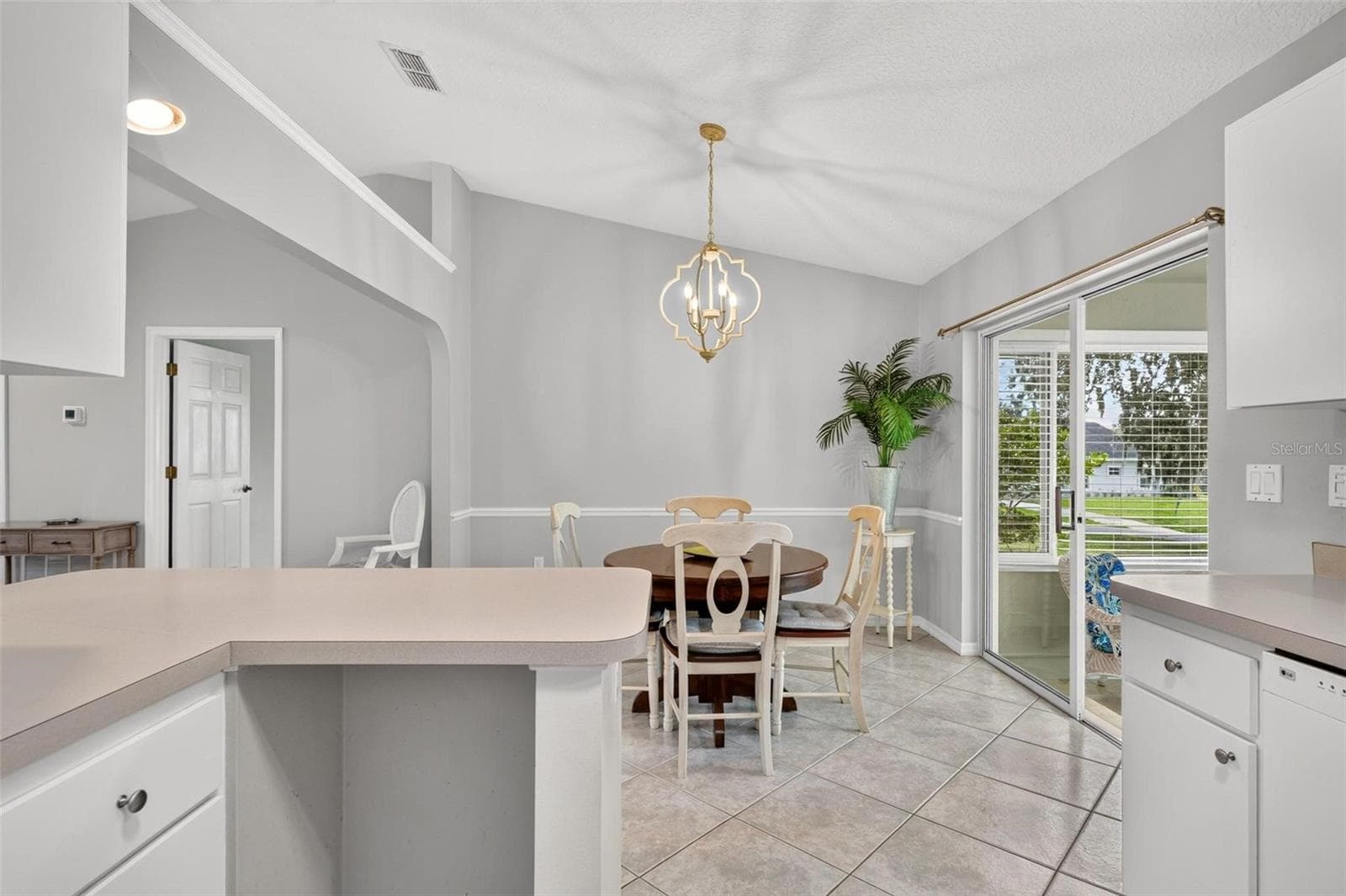 Kitchen into Dining room - 211 HANGING MOSS LN, LADY LAKE