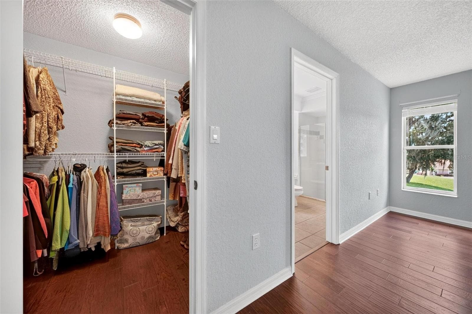 Primary bedroom walk in closet - 211 HANGING MOSS LN, LADY LAKE