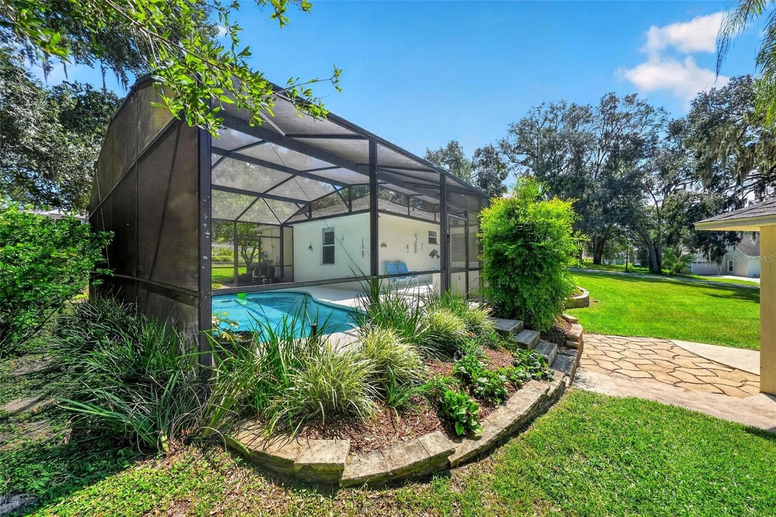 side view of pool - 211 HANGING MOSS LN, LADY LAKE