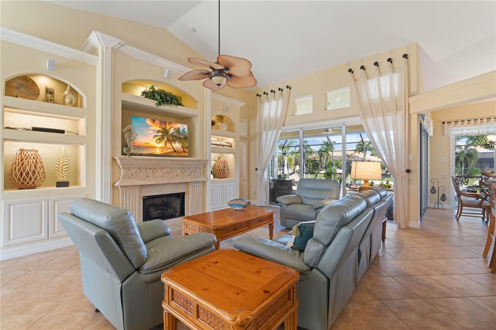 Great room with built-in fireplace and lighted display shelves - 1448 KIWI CT, PUNTA GORDA