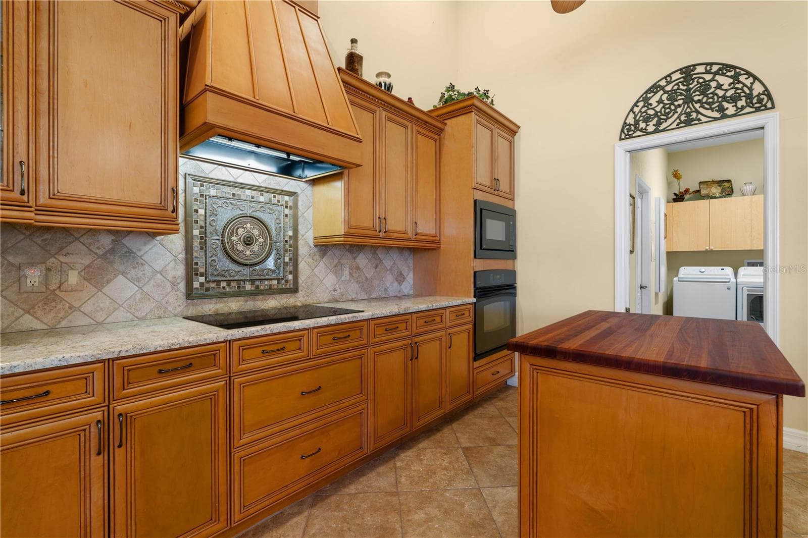 Kitchen w/mosaic tile medallion back splash. - 1448 KIWI CT, PUNTA GORDA