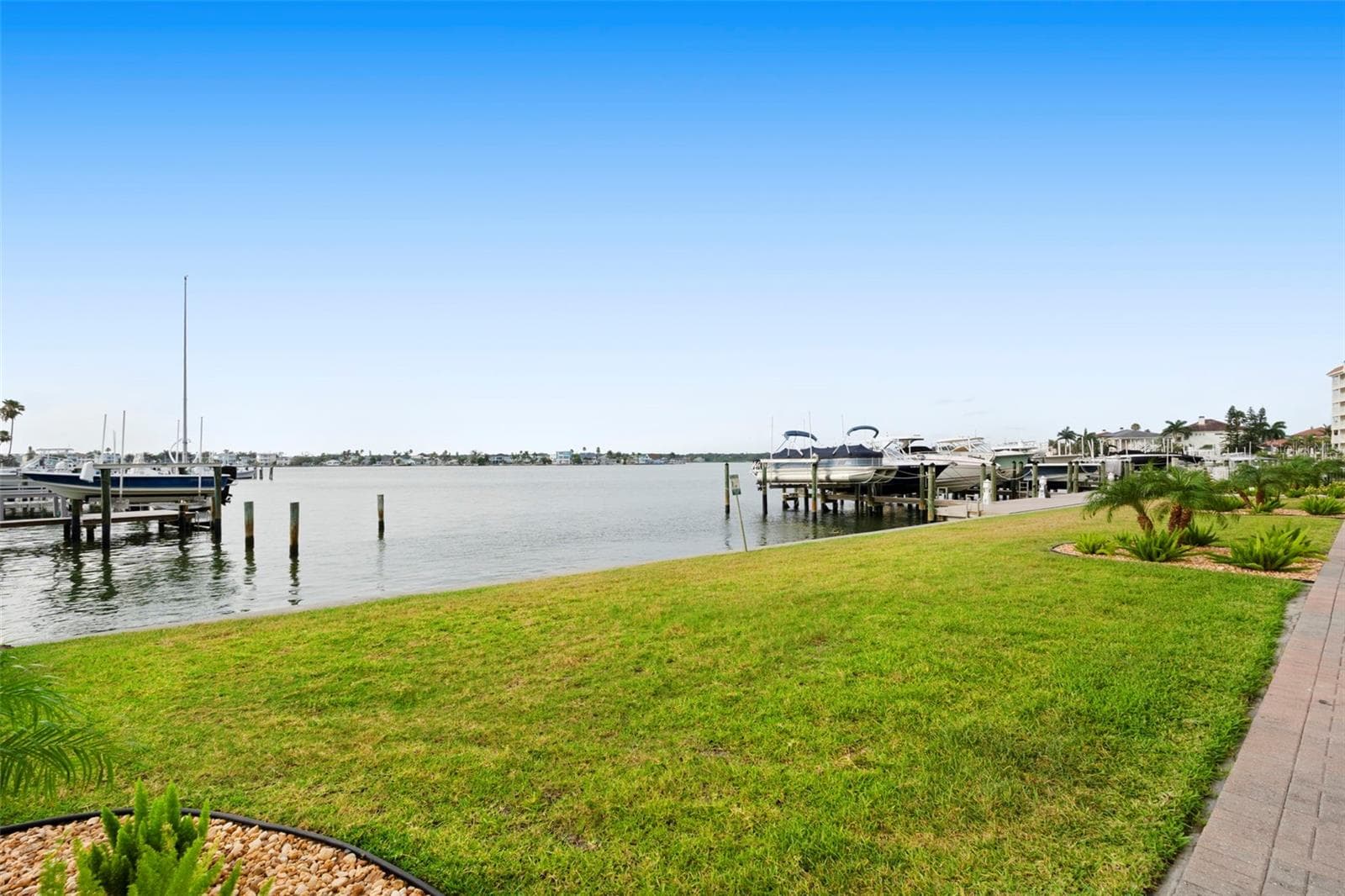 Spacious grassy area outback along back of building to water and docks perfect for residents with pets - 17717 GULF BLVD #604, REDINGTON SHORES