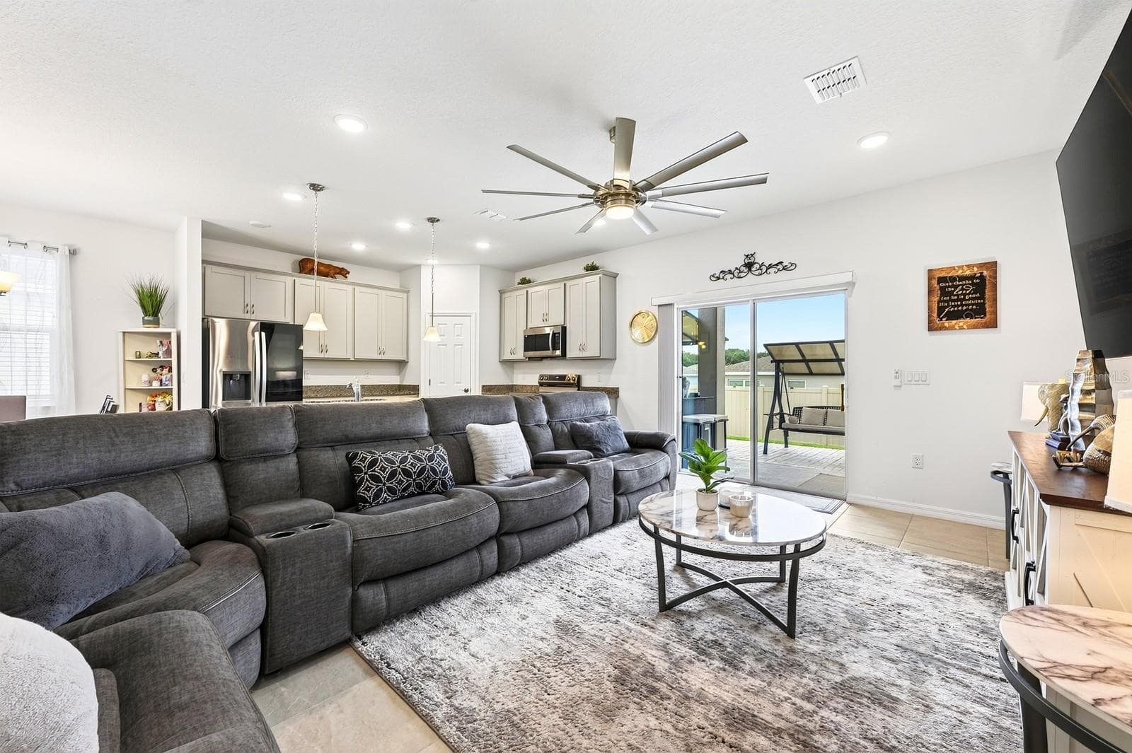 Step through the Living Room's sliding glass doors and discover an outdoor space designed for enjoying the Florida lifestyle. - 33384 COUNTRY HOUSE DR, SORRENTO