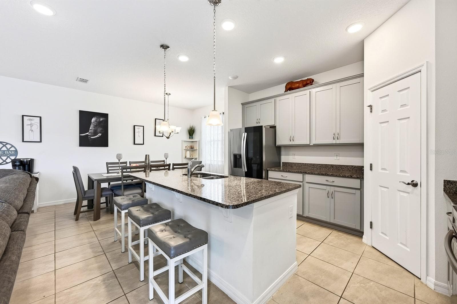 At the heart of the home, the spacious Kitchen offers an abundance of cabinetry and counter space, a large center island, BREAKFAST BAR, stainless steel appliances and a convenient WALK-IN PANTRY, keeping everyone connected to the main living spaces. - 33384 COUNTRY HOUSE DR, SORRENTO