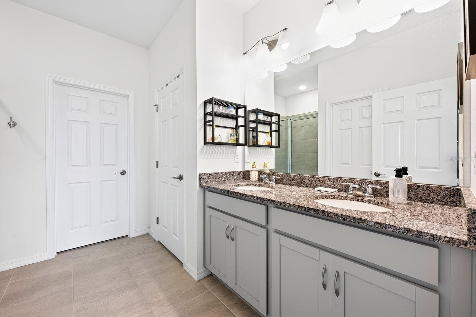 The Primary en-suite bath boasts dual sinks, a step-in shower, private water closet, linen closet and LARGE WALK-IN CLOSET. - 33384 COUNTRY HOUSE DR, SORRENTO