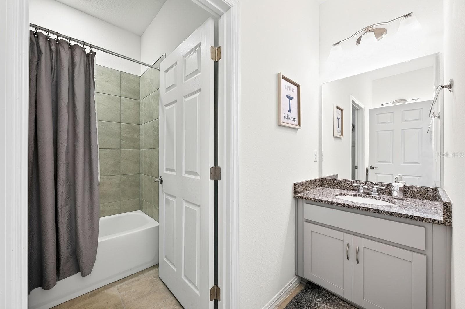 Bathroom 2 features dual vanities and a tub with shower. - 33384 COUNTRY HOUSE DR, SORRENTO