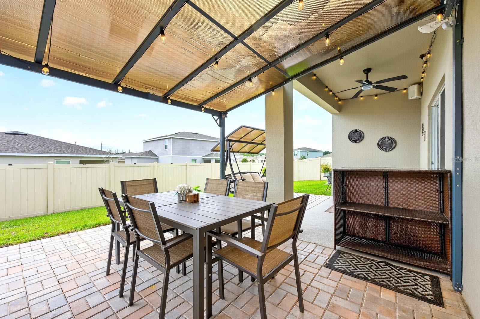 Enjoy al fresco dinners under the pergola, where the covered outdoor space creates the perfect setting for gathering with family and friends. - 33384 COUNTRY HOUSE DR, SORRENTO