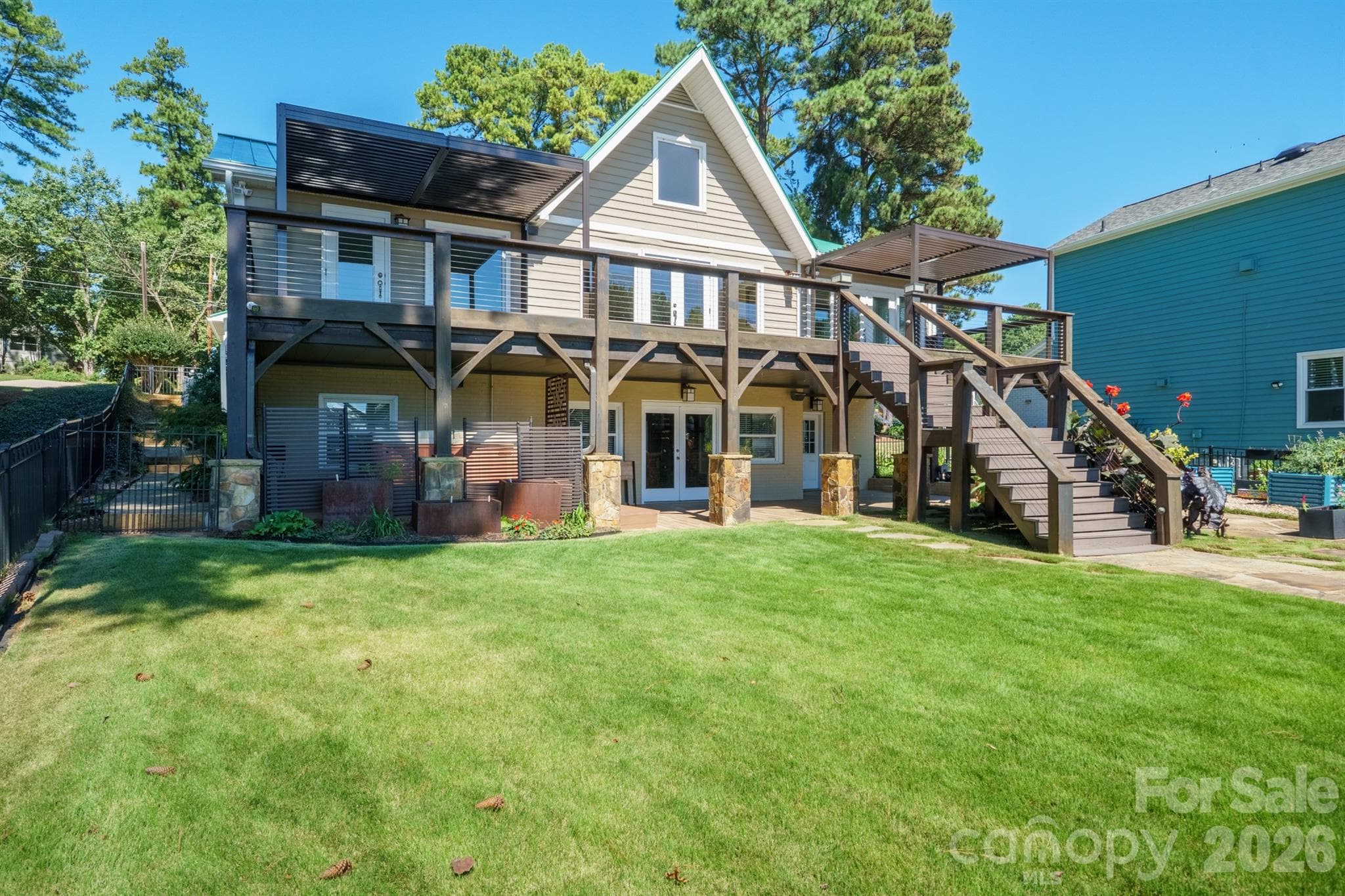 Lush backyard ready for entertaining and full bottom patio is covered from the elements with french doors to basement den or party room - 20919 Island Forest Drive, Cornelius