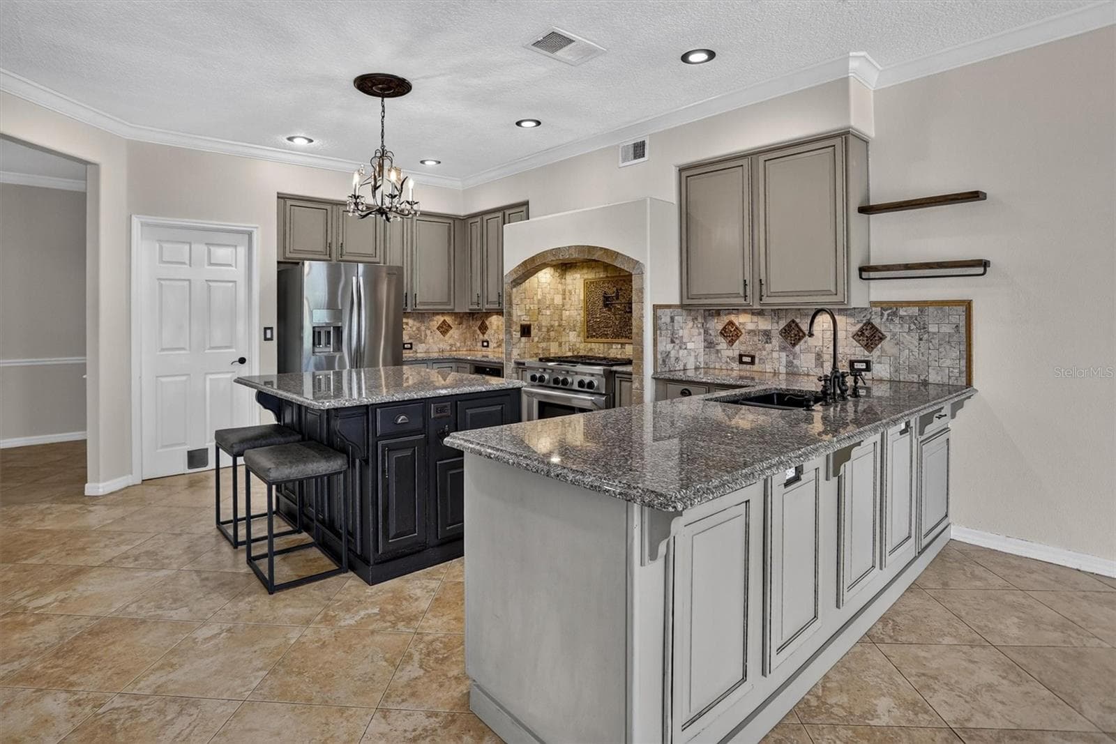 Kitchen with a large island and extensive cabinetry. - 2109 WEMBLEY PL, OVIEDO