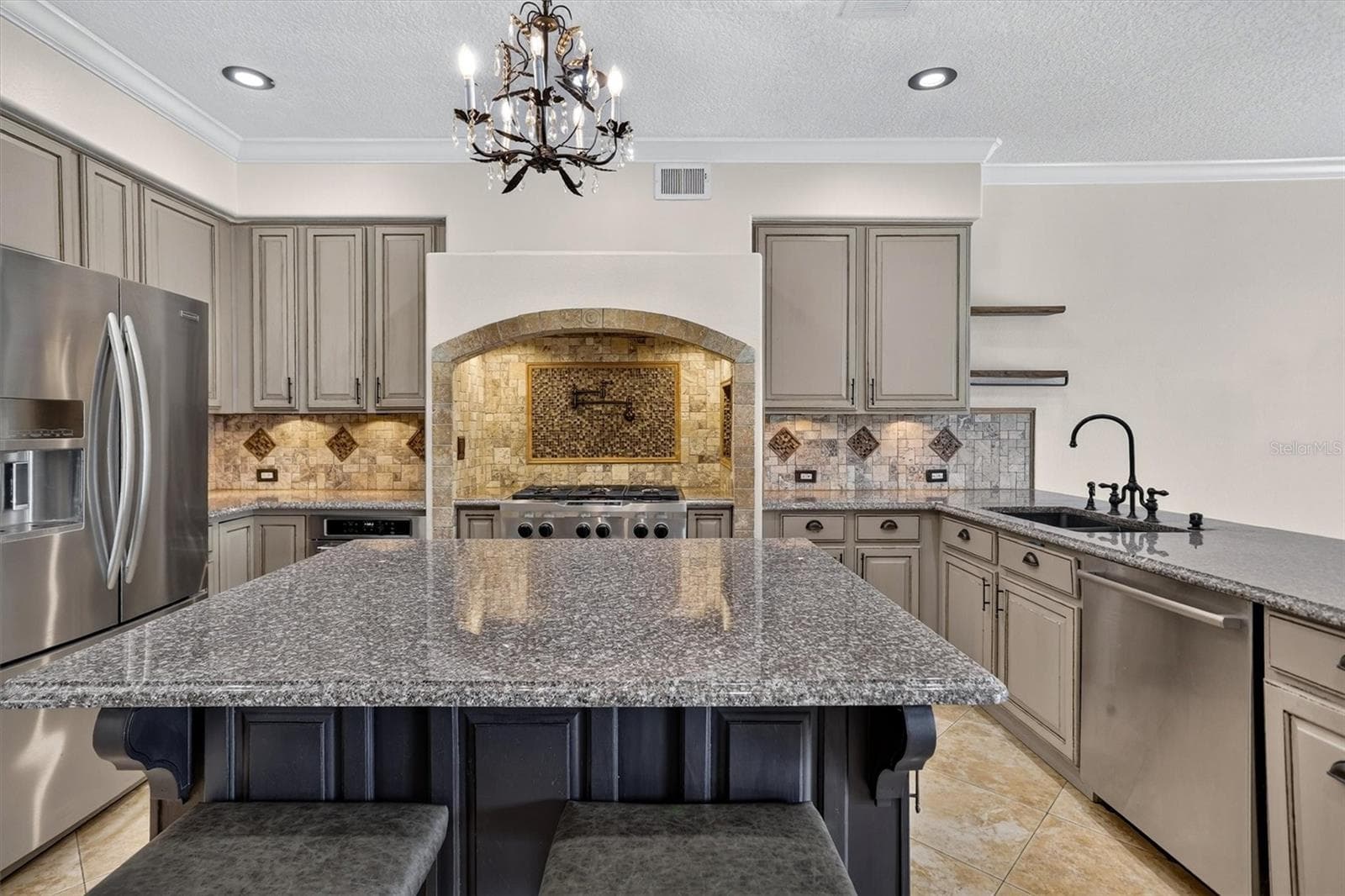 Kitchen with a large island and extensive cabinetry. - 2109 WEMBLEY PL, OVIEDO