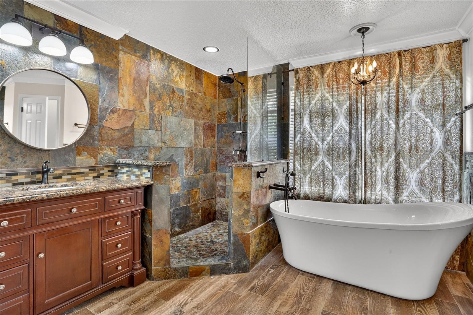 Primary bathroom with a freestanding soaking tub and oversized tiled shower. - 2109 WEMBLEY PL, OVIEDO