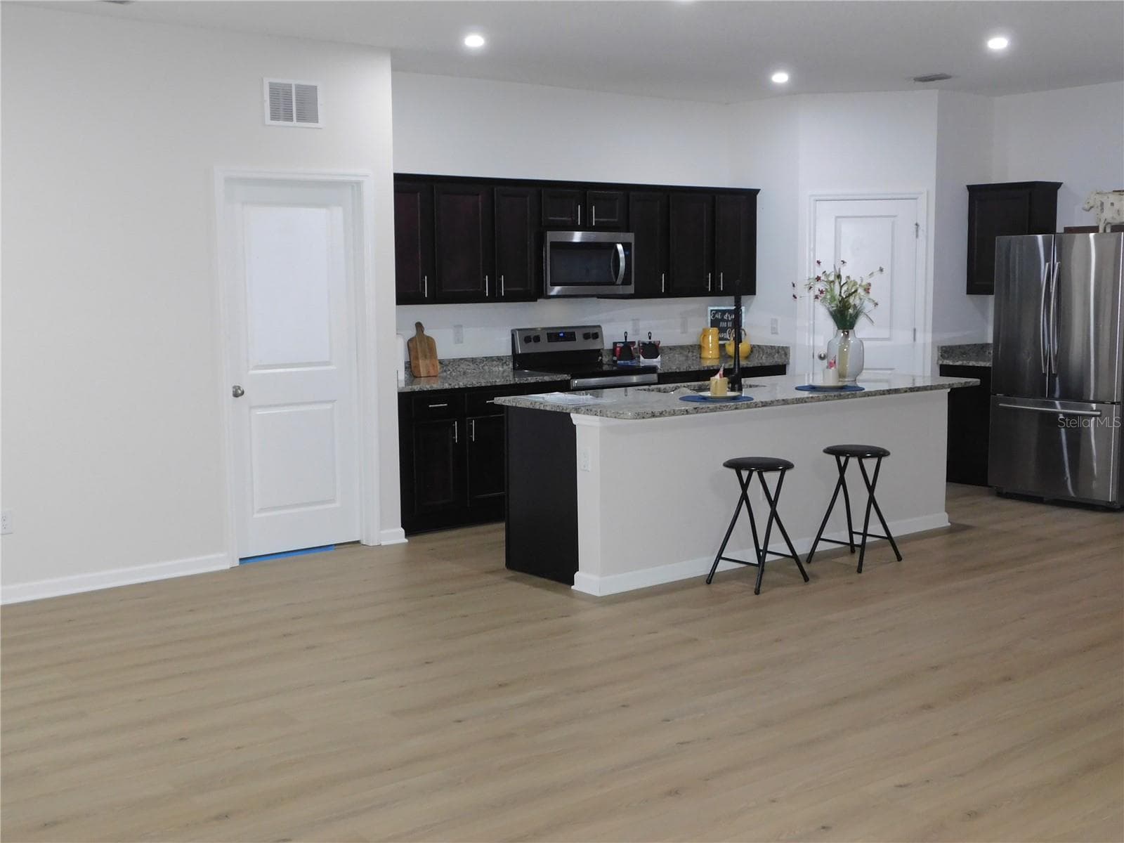 New Flooring in Large Kitchen features Oversized Granite Island Upgraded faucet and walk in pantry - 1261 ANCHOR BEND DR, RUSKIN