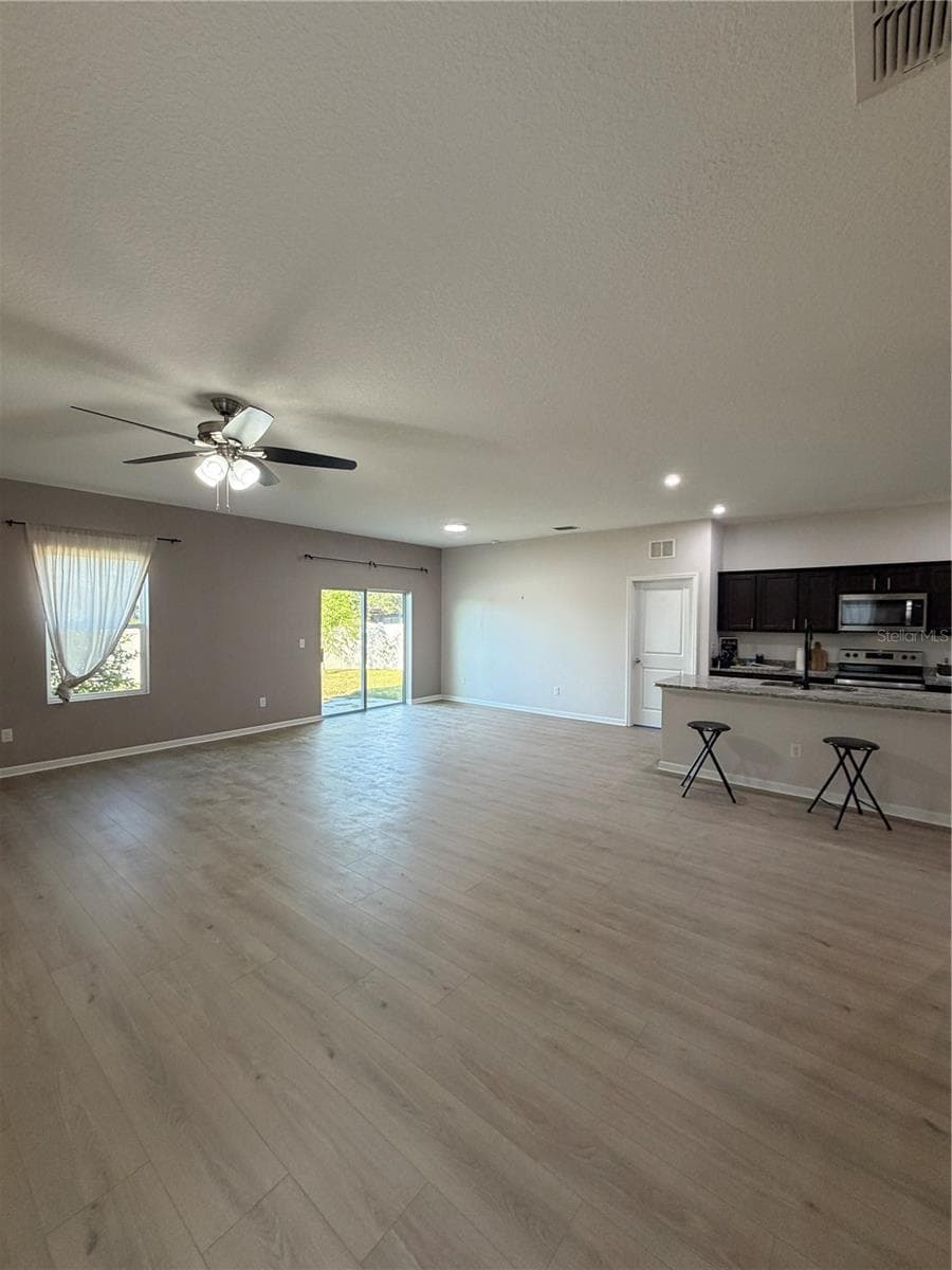 Designer LVP 9X60 throughout living areas ready to greet you! Expansive Living and Dining Areas open concept - 1261 ANCHOR BEND DR, RUSKIN