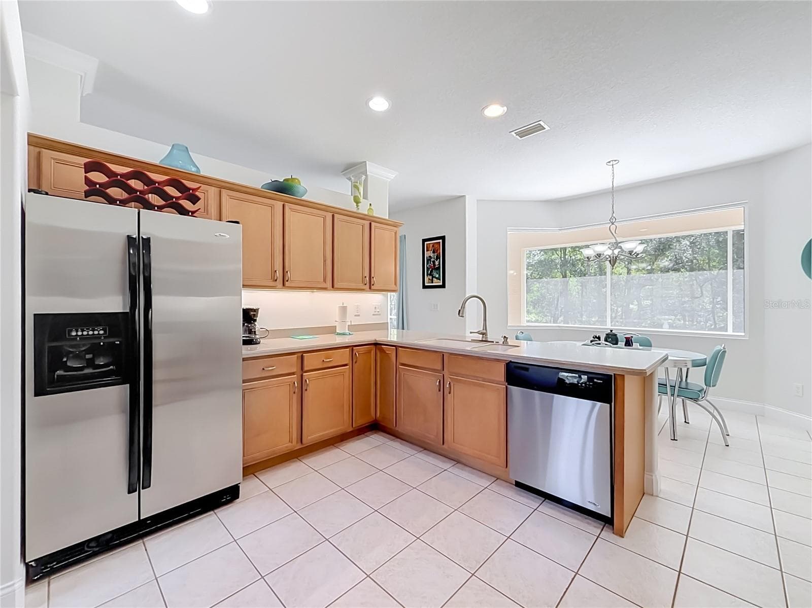 Kitchen with stainless appliances and abundant wood cabinetry - 2452 W ARBUTUS DR, CITRUS SPRINGS