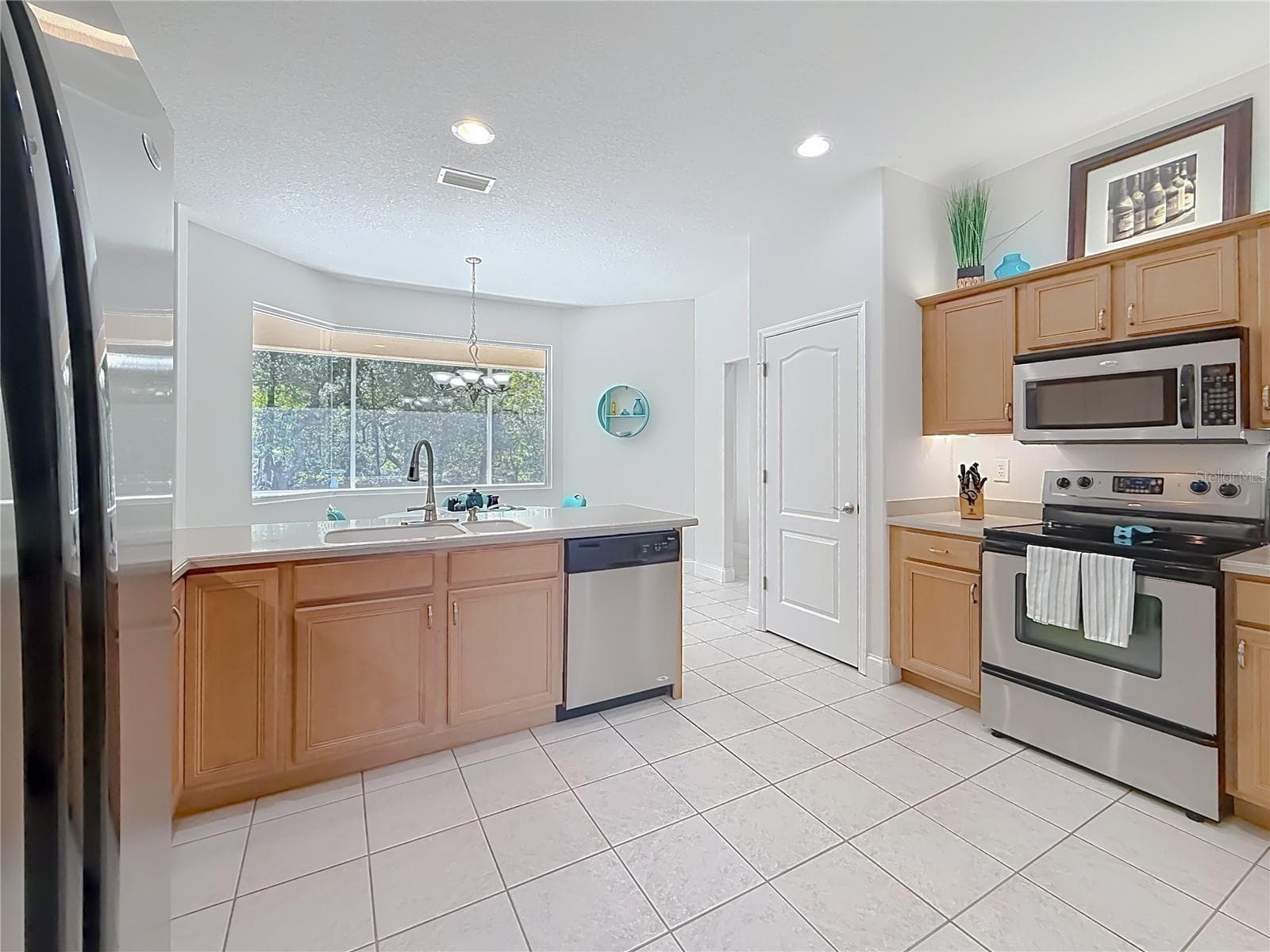 Kitchen with pass-through window and tile floors - 2452 W ARBUTUS DR, CITRUS SPRINGS