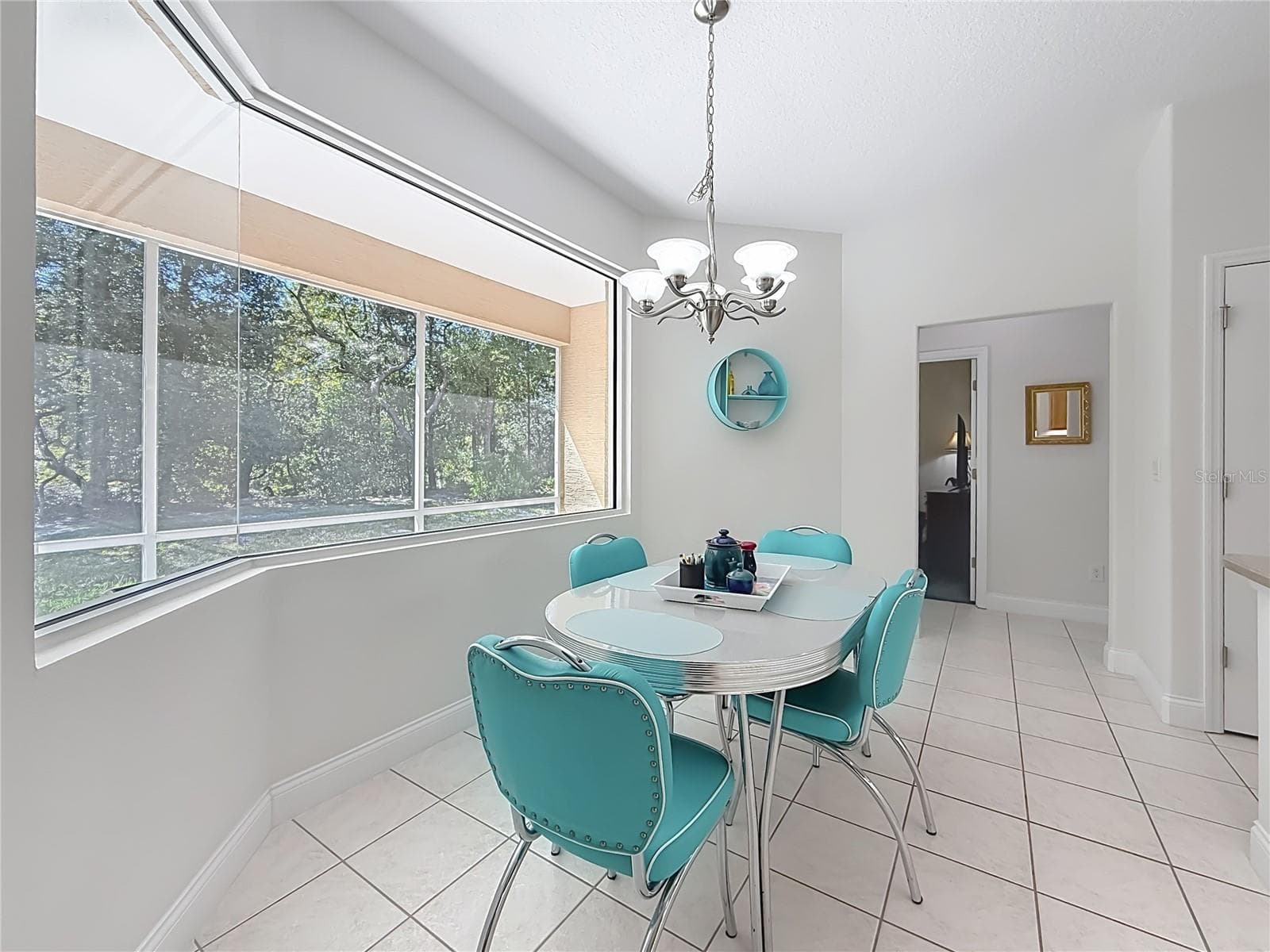 Dining nook with a wall of windows and chandelier - 2452 W ARBUTUS DR, CITRUS SPRINGS