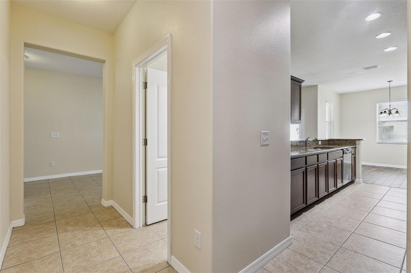 Hallway to half bath, garage and large hall closet - 15515 CAMPDEN ST, WINTER GARDEN