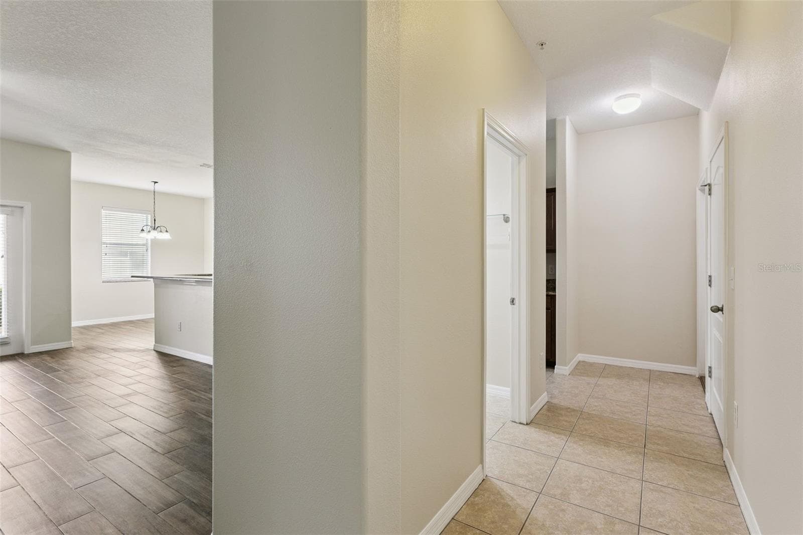 Hallway to half bath, large storage closet, garage and additional kitchen entry/exit - 15515 CAMPDEN ST, WINTER GARDEN