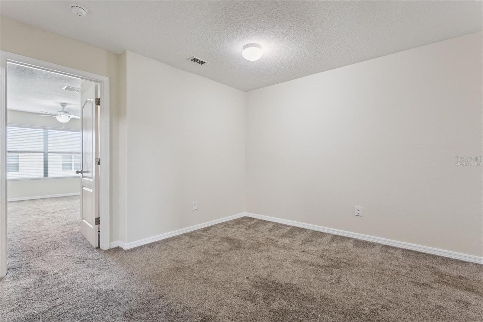 Loft area looking towards primary bedroom, same photo as virtually staged - 15515 CAMPDEN ST, WINTER GARDEN