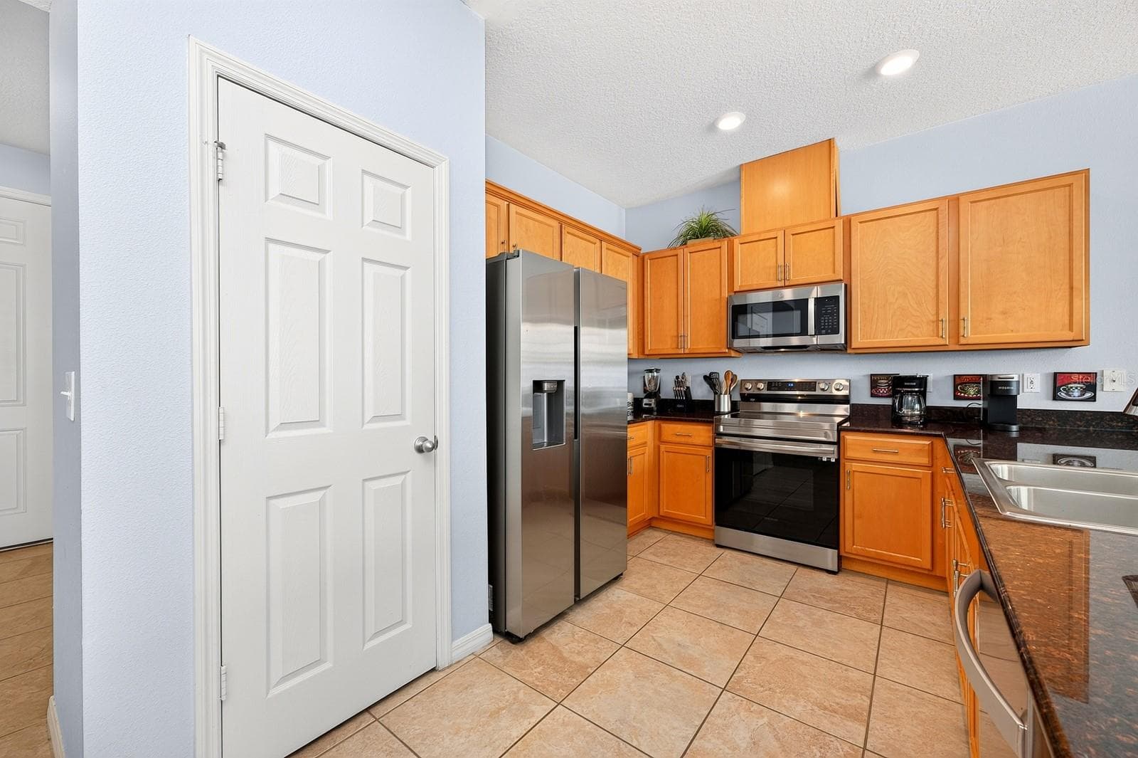 The kitchen delivers stainless steel appliances and ample storage. - 5109 KILLARNEY WAY, KISSIMMEE
