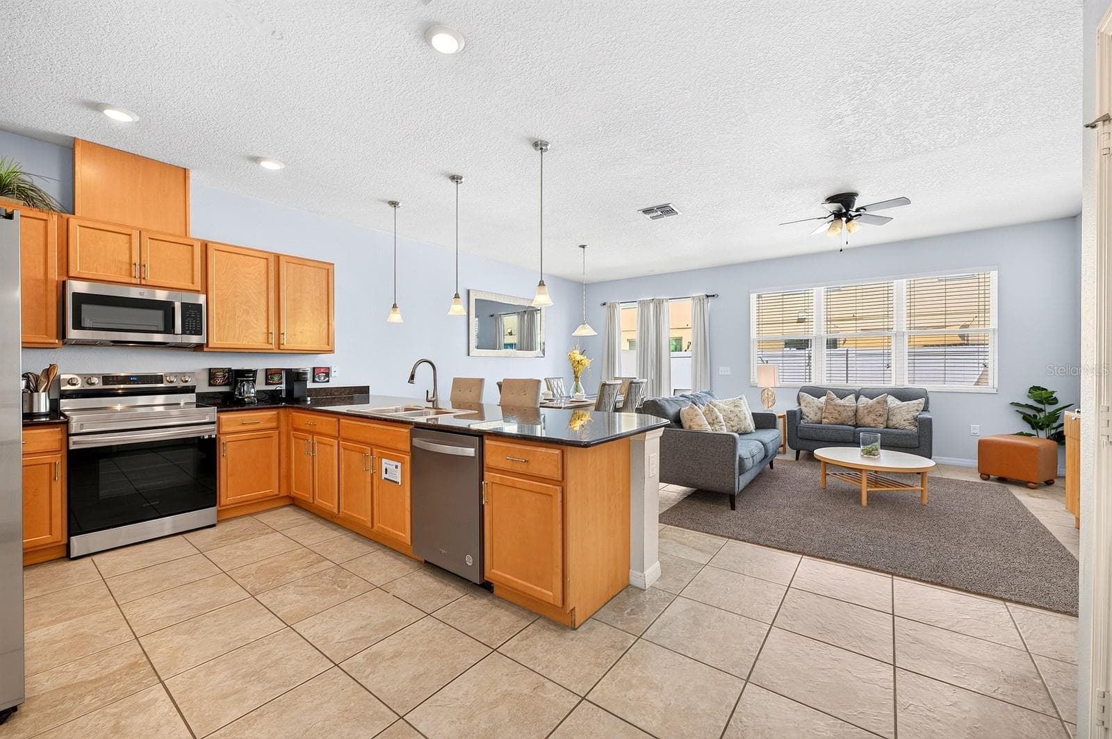 The kitchen is open to the living and dining areas. - 5109 KILLARNEY WAY, KISSIMMEE