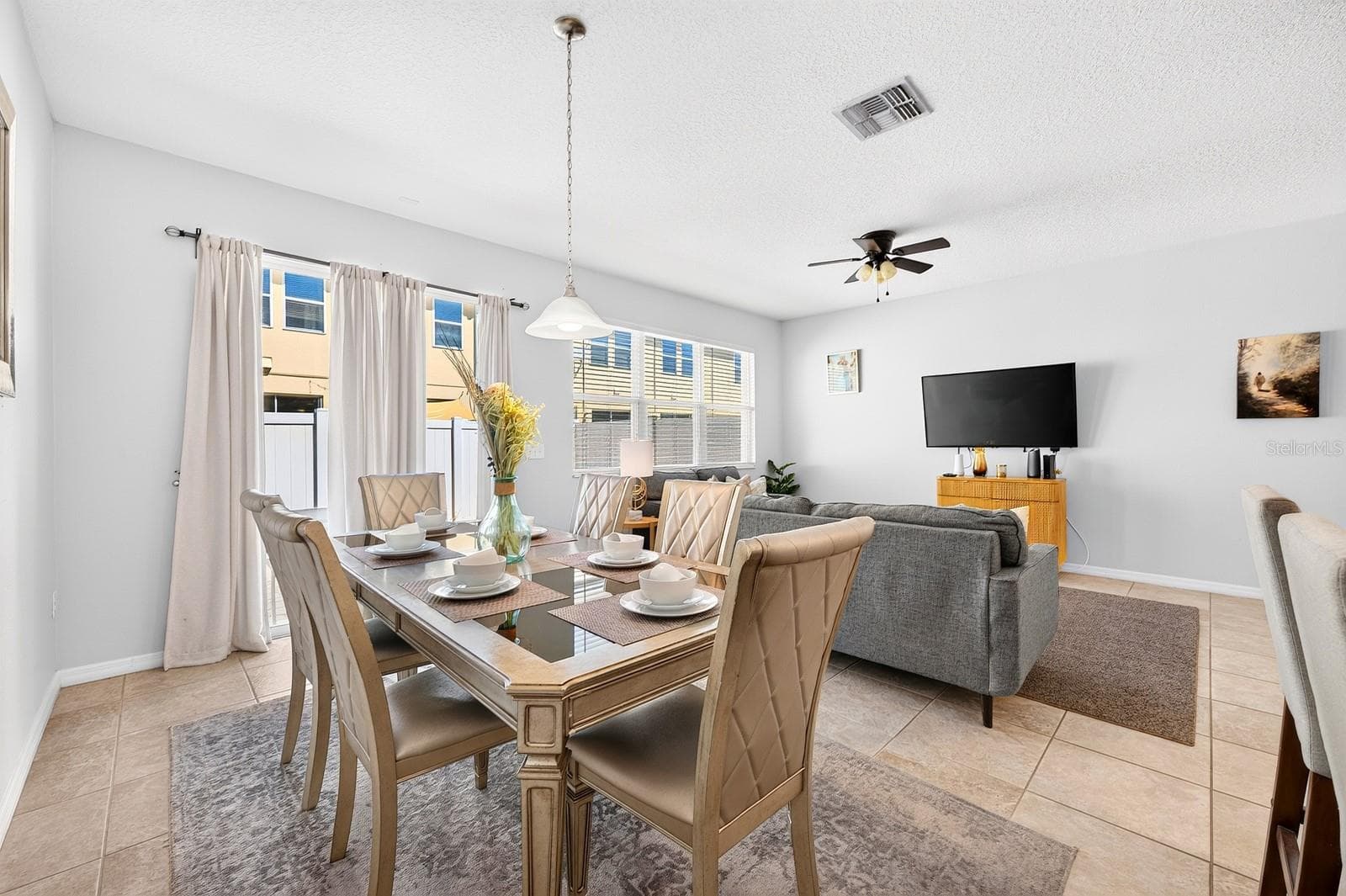 Enjoy natural light from the wall of windows. - 5109 KILLARNEY WAY, KISSIMMEE