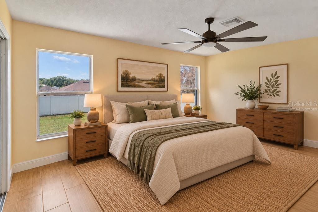 Virtually Staged - Primary bedroom with slider access to patio - 10814 VINEYARD CT, CLERMONT