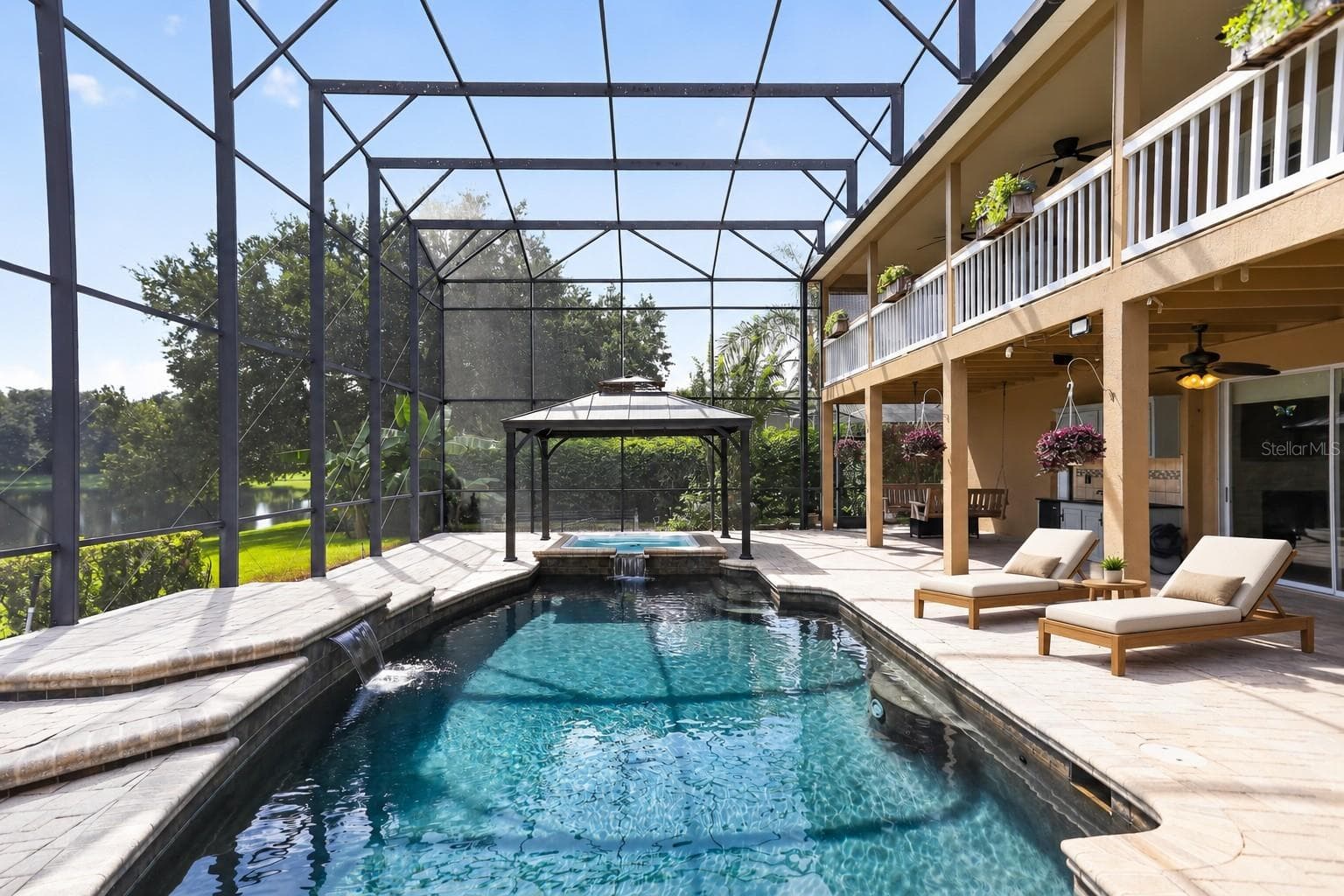 Resort-style saltwater pool with expansive screened outdoor living, an upper balcony and tranquil pond views. - 2109 WEMBLEY PL, OVIEDO