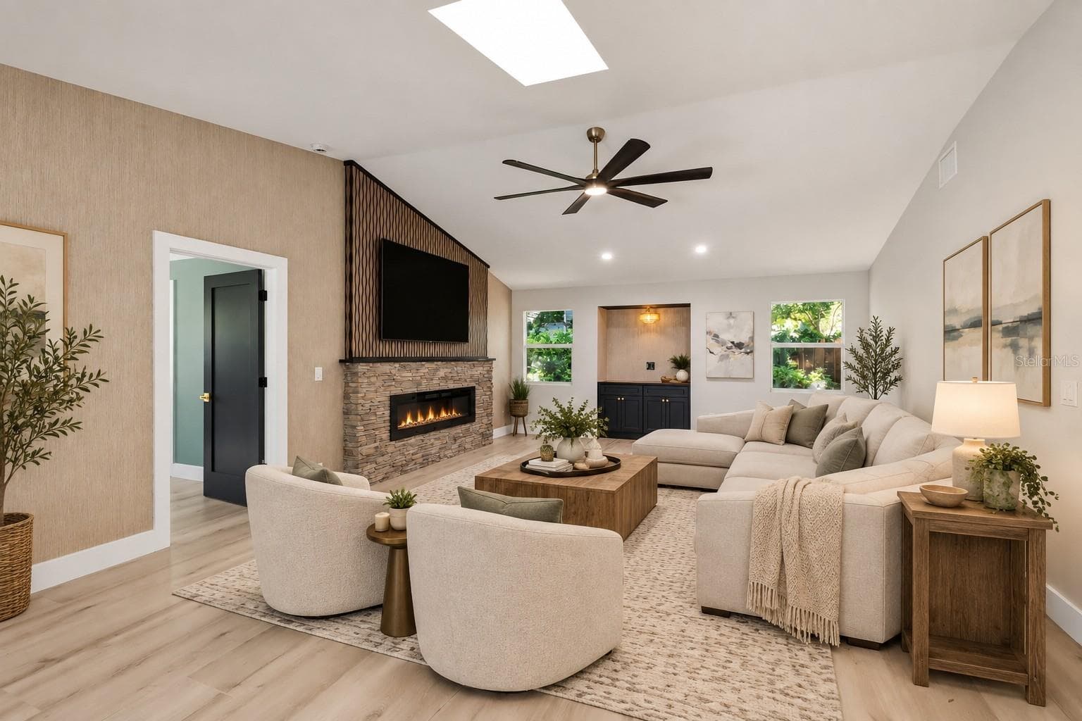 Family room featuring stunning accent wall and fireplace - 1411 70TH ST NW, BRADENTON