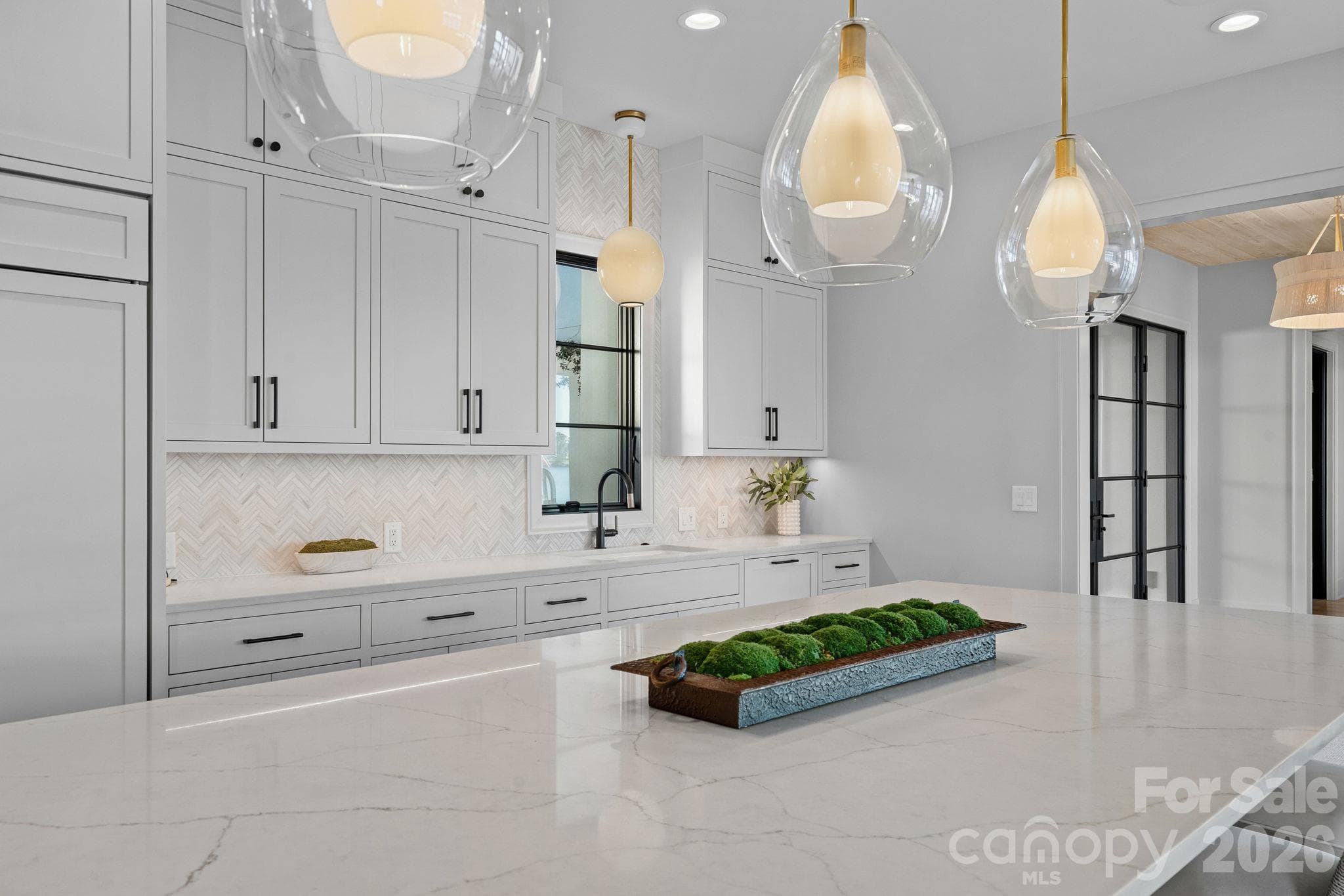 Designer kitchen with statement island, custom cabinetry, Wolf appliances and curated finishes. - 17811 Largo Place, Cornelius