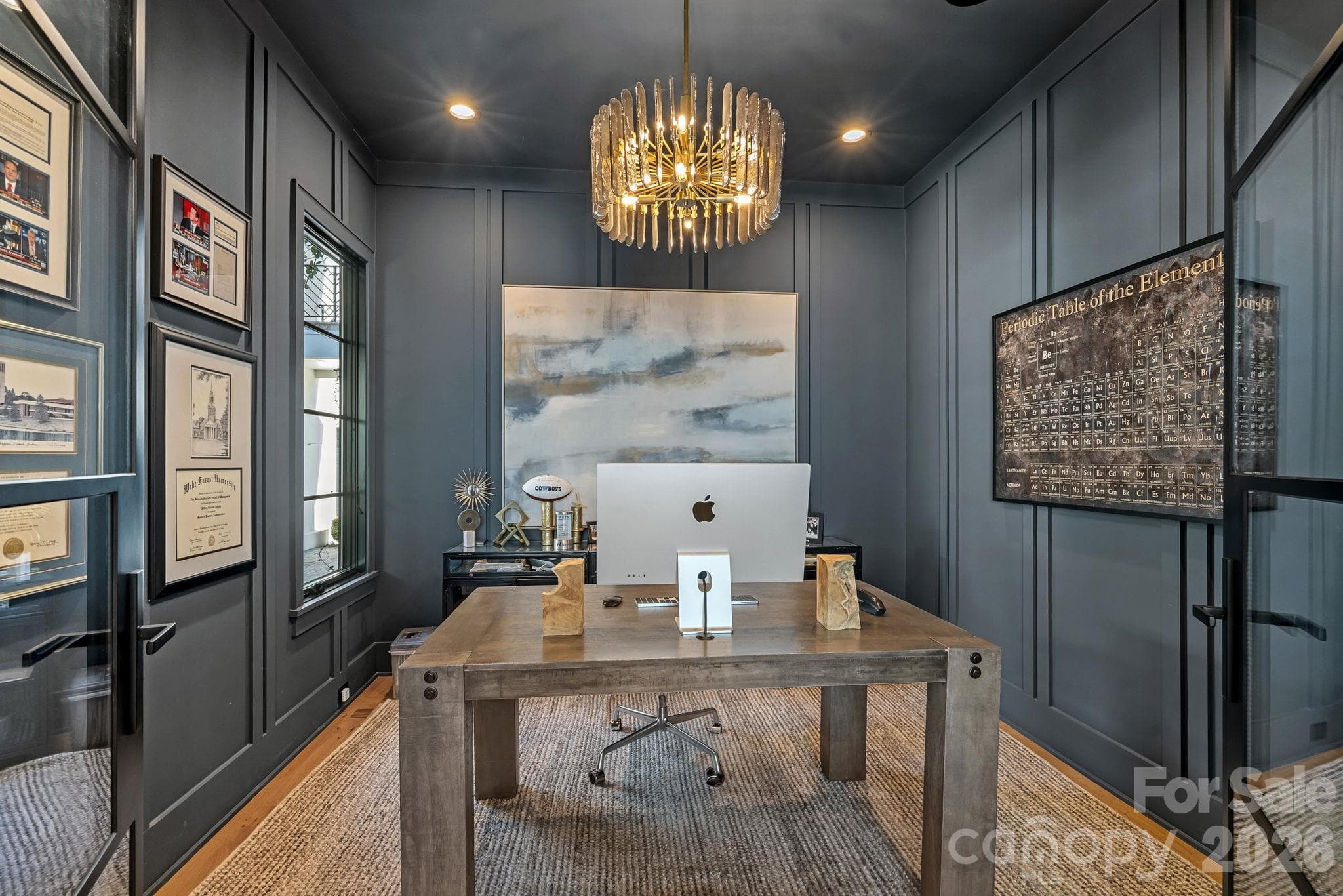 Moody, sophisticated study defined by custom wall paneling, glass doors and sculptural statement lighting. - 17811 Largo Place, Cornelius