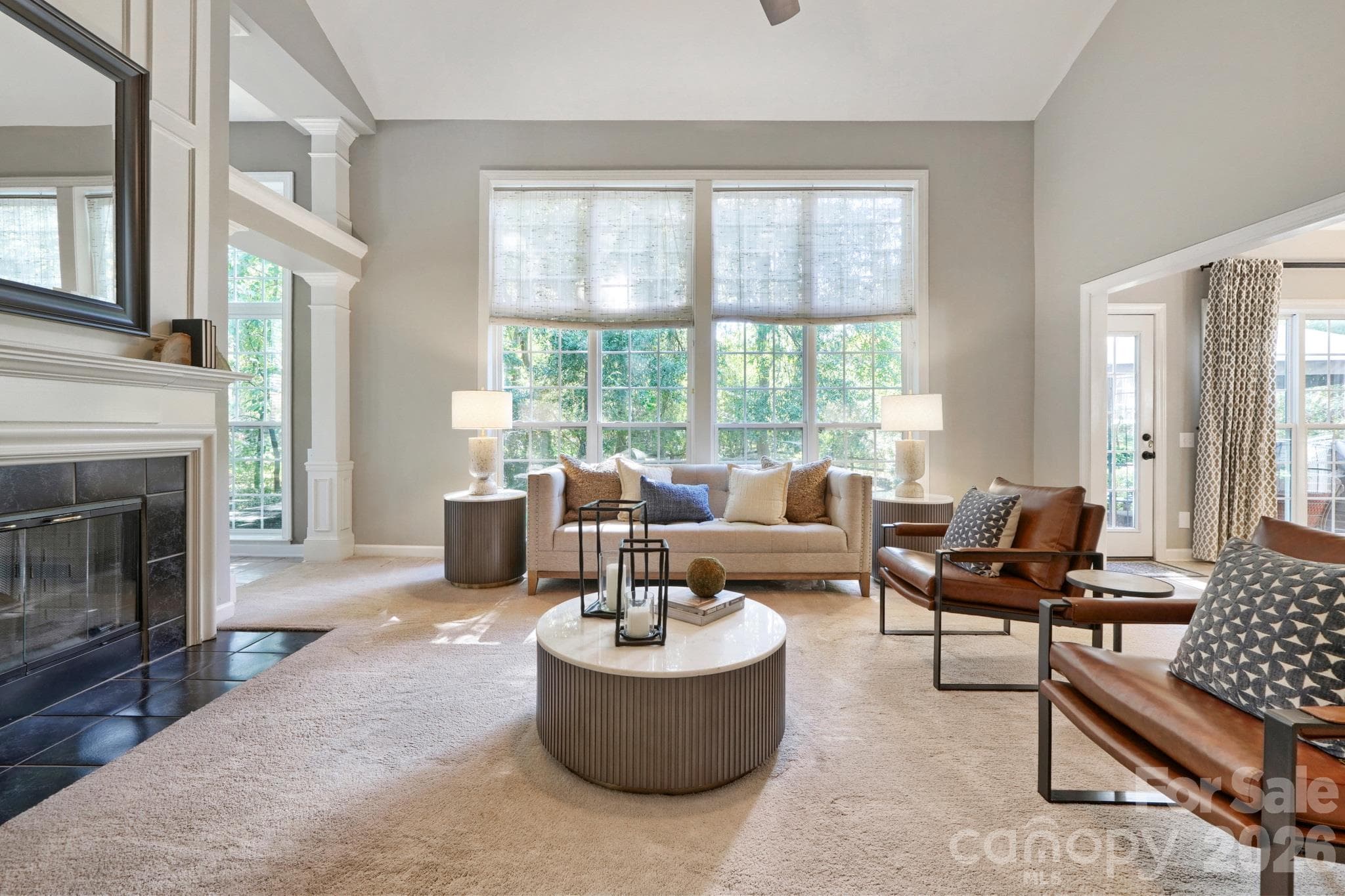 Two story light filled living room with two sided gas fireplace - 10808 Pomerane Place, Charlotte